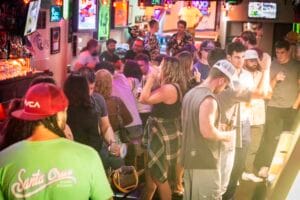 Crowded interior of the Silver Fox Lounge Pacific Beach with patrons standing, chatting, and drinking