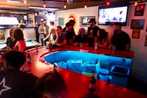 Patrons standing and chatting at the counter, Silver Fox Lounge Pacific Beach.