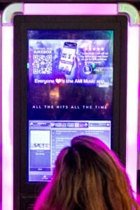 Close-up of a person standing in front of the jukebox, Silver Fox Lounge Pacific Beach.